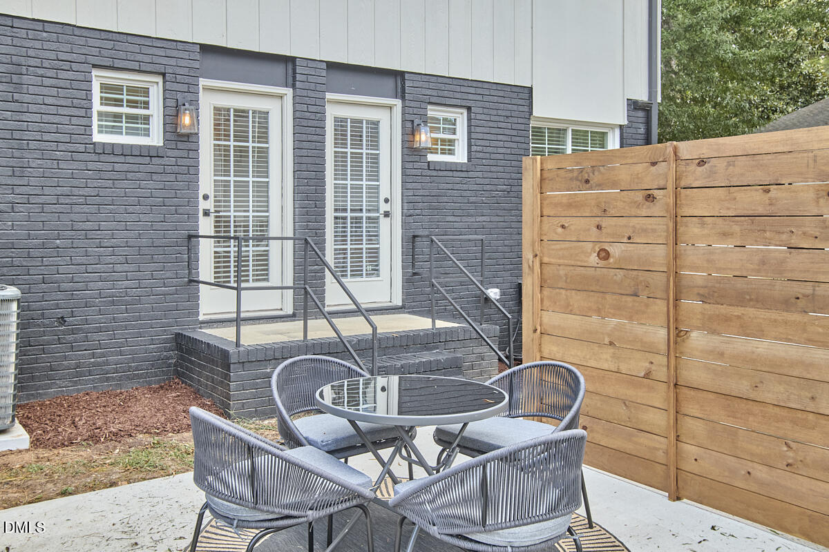 2613 McNeil Street, Unit B Raleigh, NC 27608 - Photo 29 of 31 a table and chairs in a patio