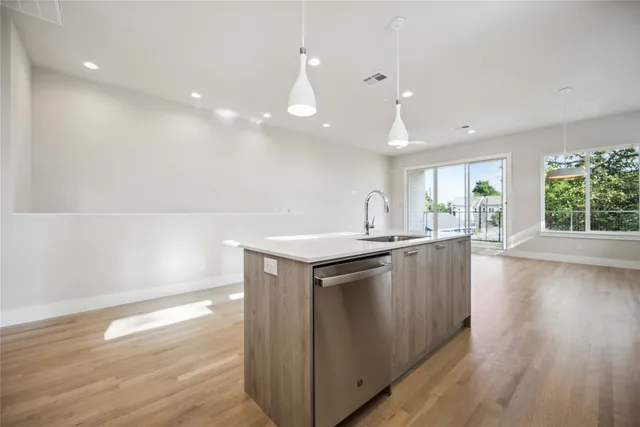 a kitchen with granite countertop a stove and wooden floor