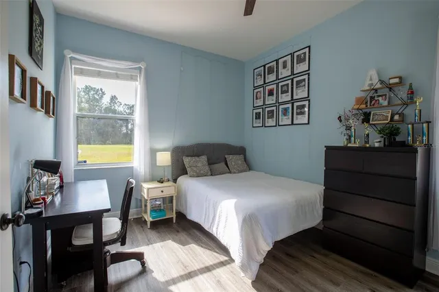 a bedroom with a bed and a table in it