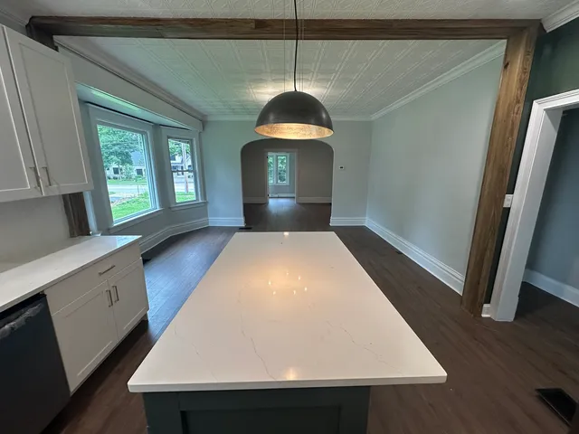 a kitchen with a sink a wooden floor and a window
