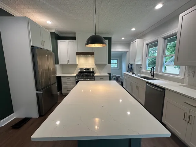 a view of a kitchen with a sink and wooden floor