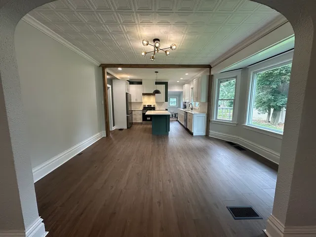 a view of living room with furniture and chandelier