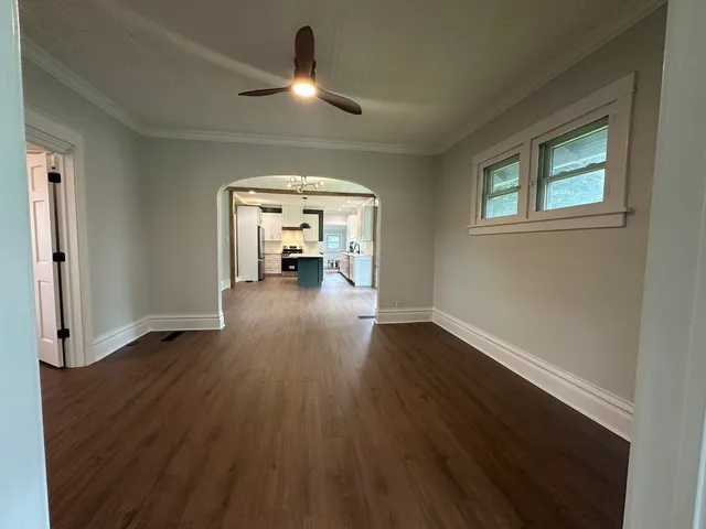 wooden floor in an empty room with a window