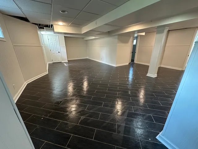 a bathroom with glass door shower and a sink