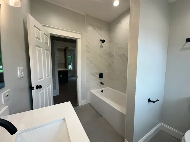 a bathroom with a bathtub and a shower