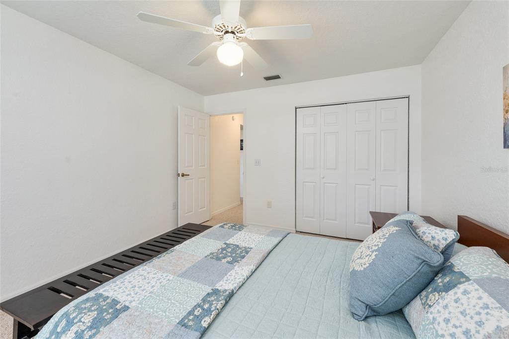 8038 Southwest 108th Loop Ocala, FL 34481 - Photo 27 of 48 a bedroom with a bed and a chandelier