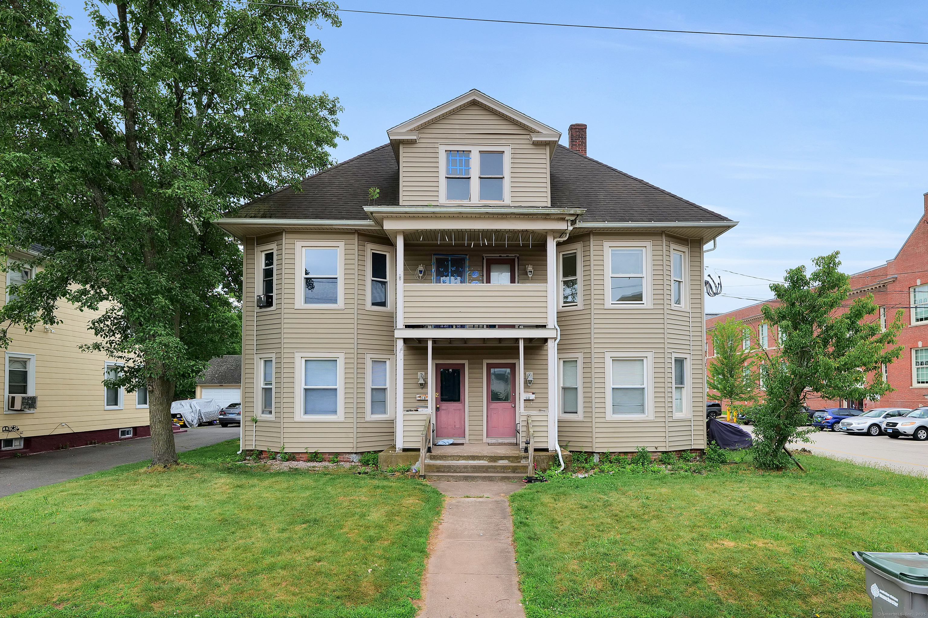 a front view of a house with a garden