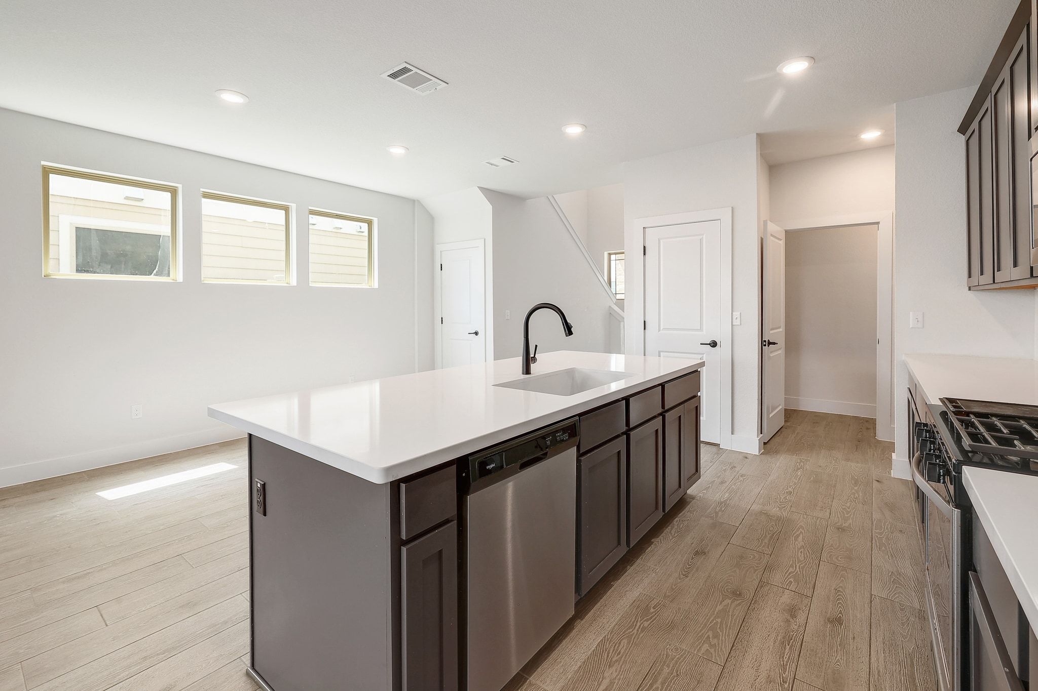 6111 Dunfries Lane Austin, TX 78744 - Photo 11 of 30 a kitchen with a sink refrigerator and microwave