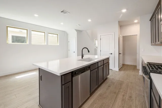 a kitchen with a sink refrigerator and microwave