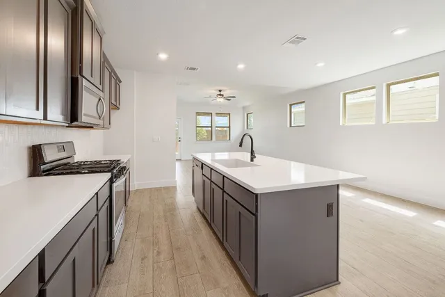 a kitchen with a sink and stove