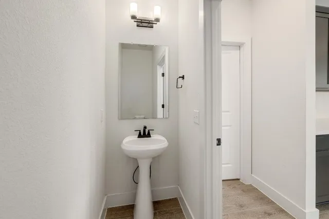 a bathroom with a sink a mirror and toilet