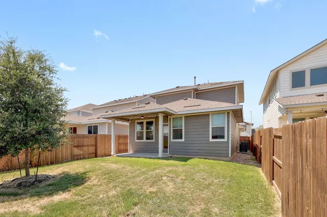 a view of a house with a backyard