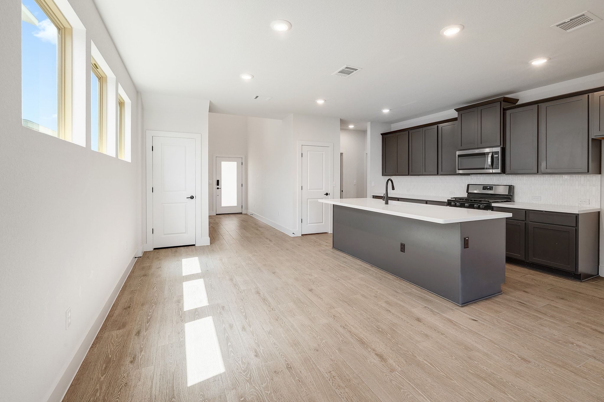 6111 Dunfries Lane Austin, TX 78744 - Photo 6 of 30 a kitchen with kitchen island granite countertop a sink and cabinets