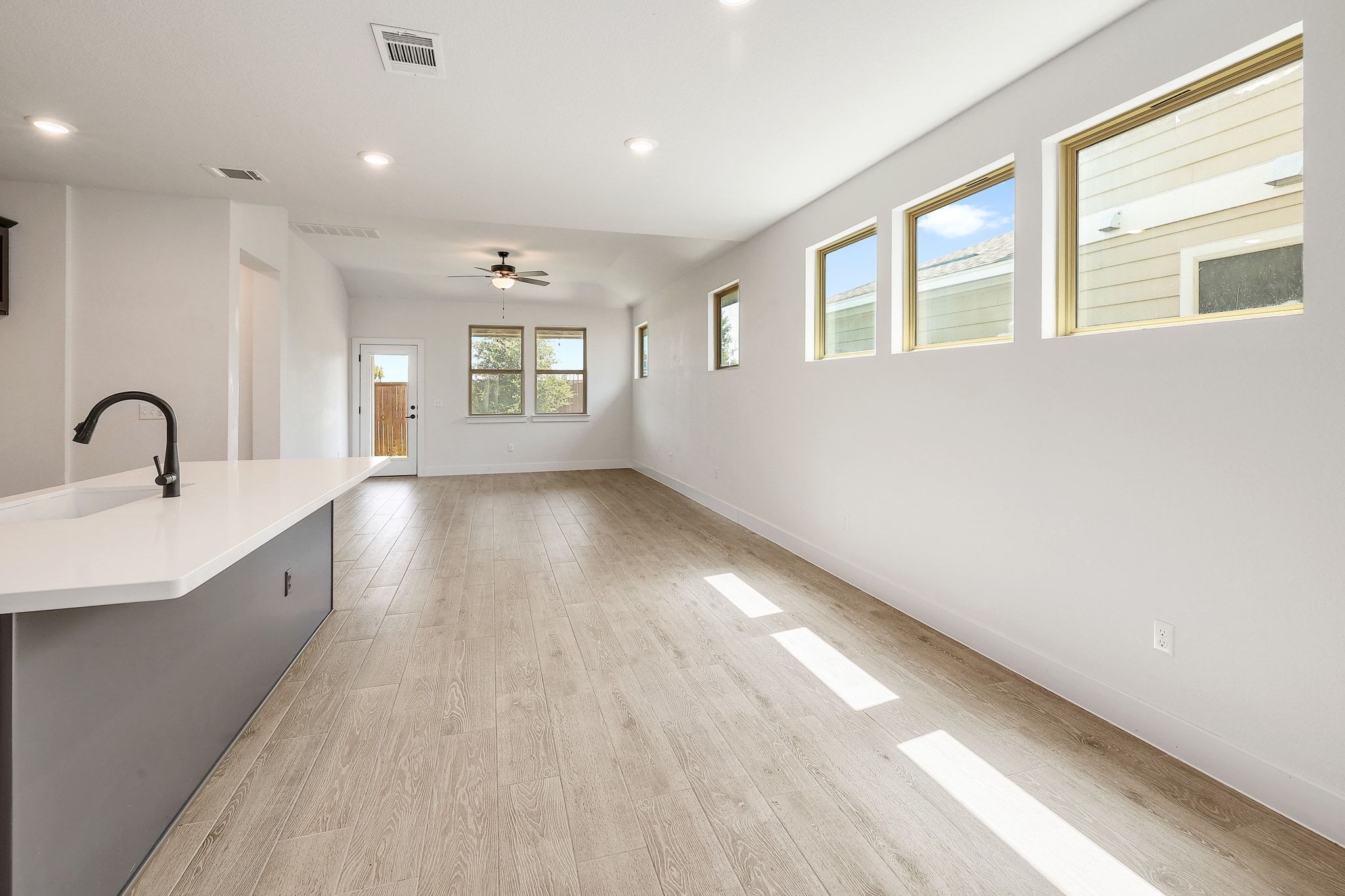 6111 Dunfries Lane Austin, TX 78744 - Photo 8 of 30 a view of an empty room with wooden floor and a window