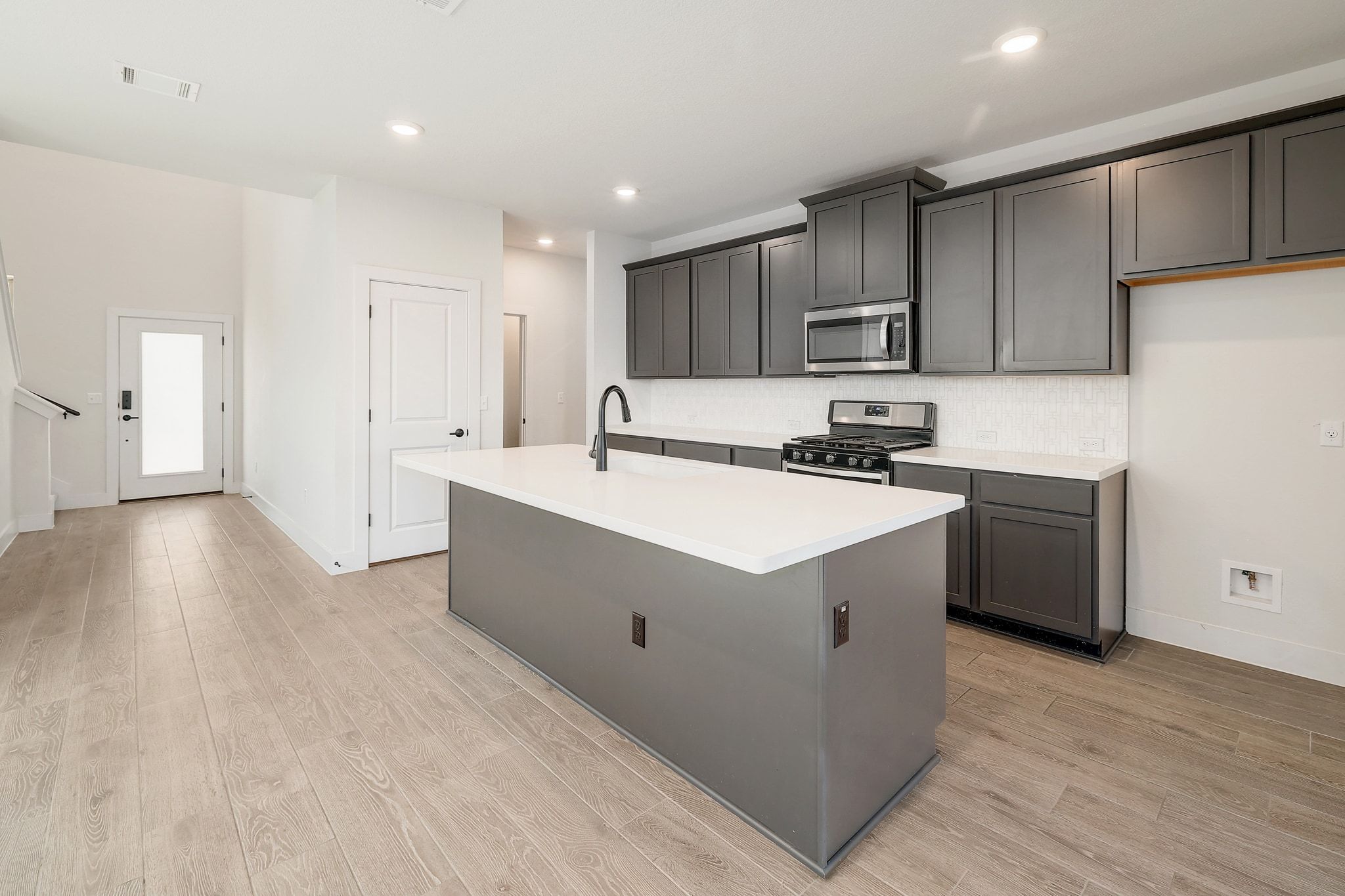 6111 Dunfries Lane Austin, TX 78744 - Photo 10 of 30 a kitchen with a sink cabinets and wooden floor