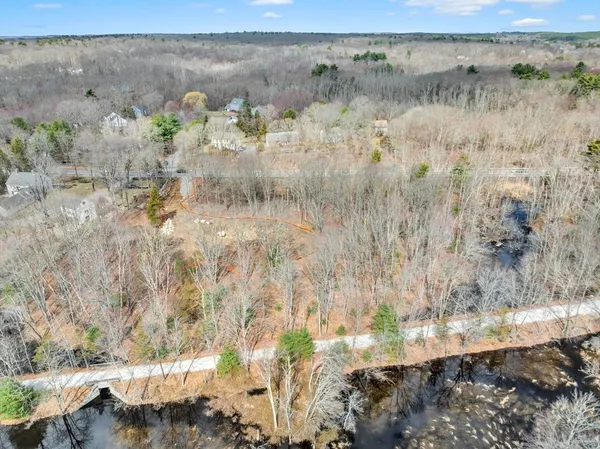 a view of a yard with a wooden fence
