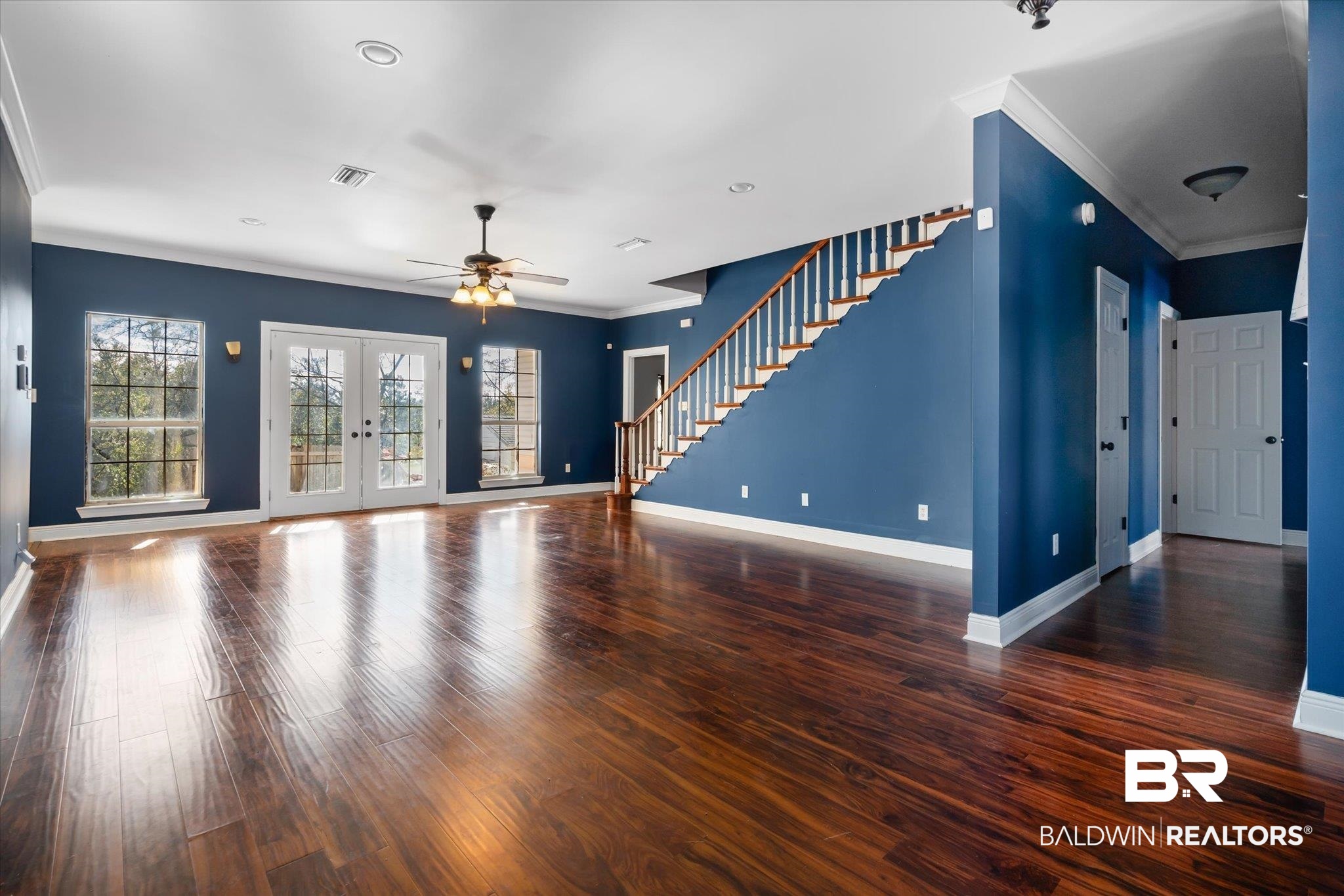 20792 Lonnie Walker Road Citronelle, AL 36522 - Photo 2 of 19 Unfurnished living room featuring french doors, ceiling fan, ornamental molding, and dark hardwood / wood-style flooring