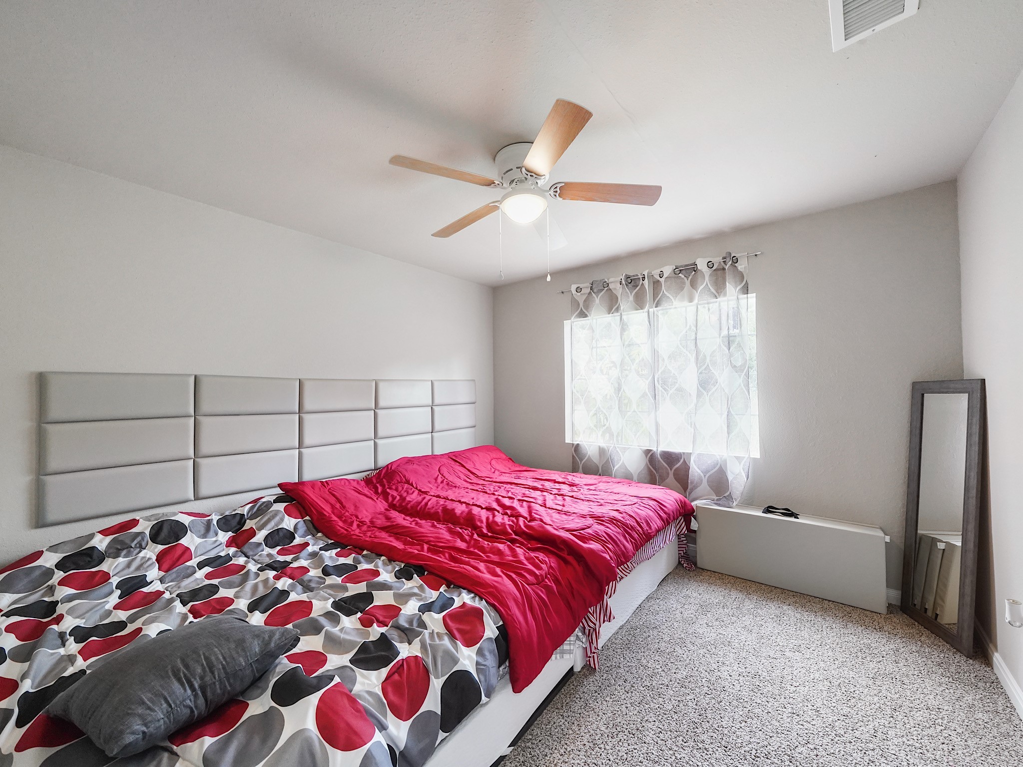 29 County Road 2131, Unit A Cleveland, TX 77327 - Photo 11 of 24 a bedroom with a bed and a chandelier