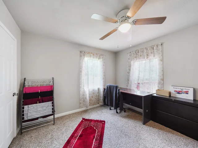 a bedroom with a bed and window