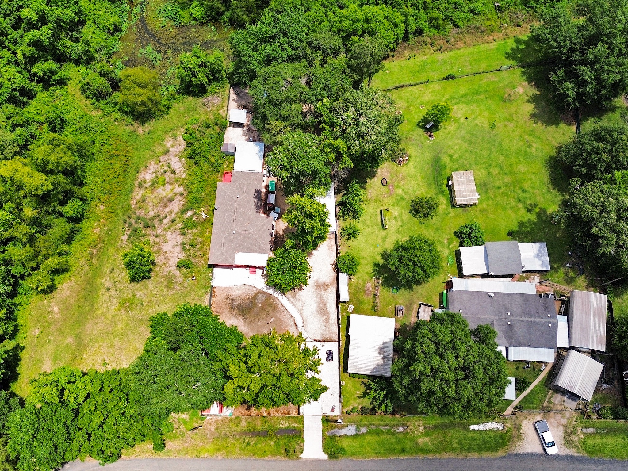 29 County Road 2131, Unit A Cleveland, TX 77327 - Photo 23 of 24 an aerial view of residential houses with outdoor space and trees all around