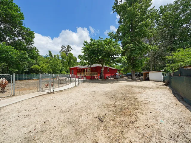 a green field with trees in the background