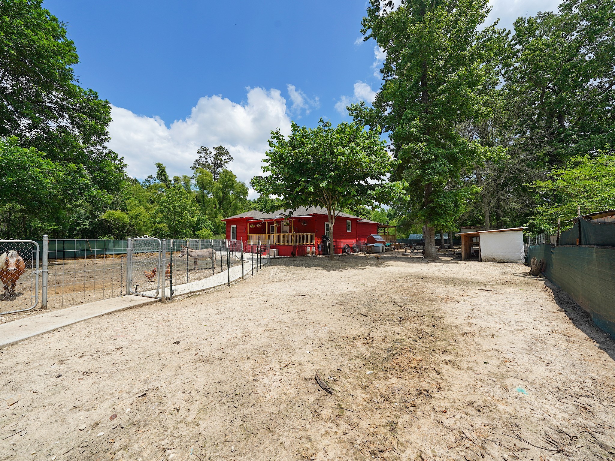 29 County Road 2131, Unit A Cleveland, TX 77327 - Photo 4 of 24 a view of a yard with wooden fence