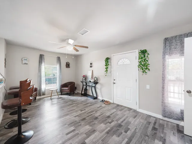 a view of a room with furniture and a window