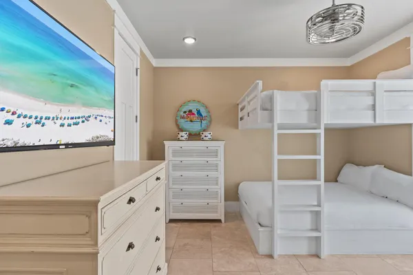a bedroom with a large bed and a chandelier