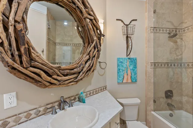 a view of a patio with couches and table and chairs with wooden floor and fence