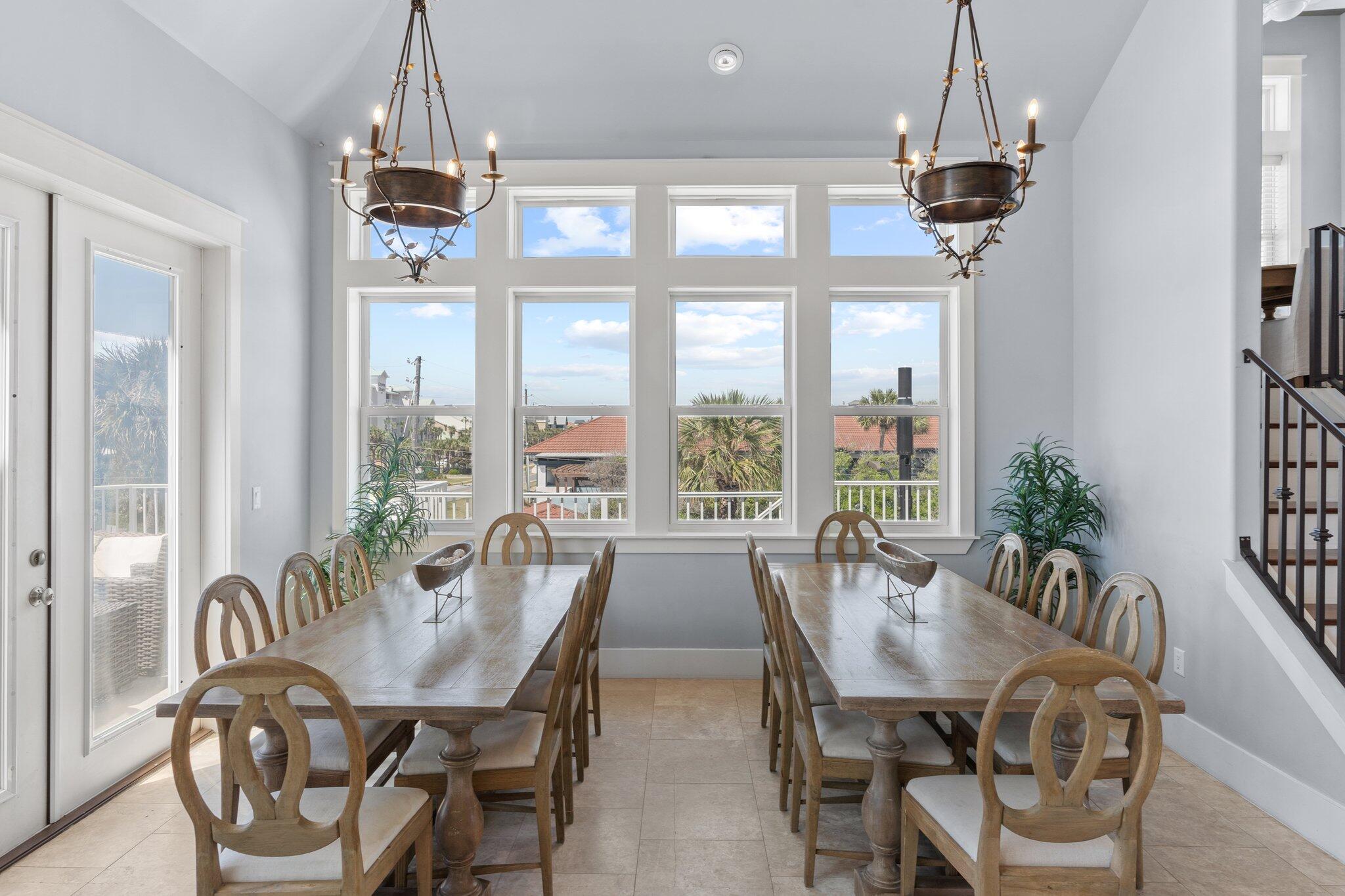 4478 Ocean View Drive Destin, FL 32541 - Photo 76 of 122 a dining room with furniture a chandelier and window