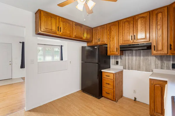 a utility room with stainless steel appliances a sink and cabinets
