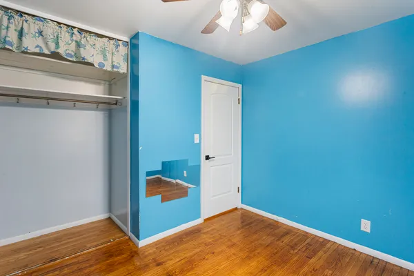 a view of a room with wooden floor