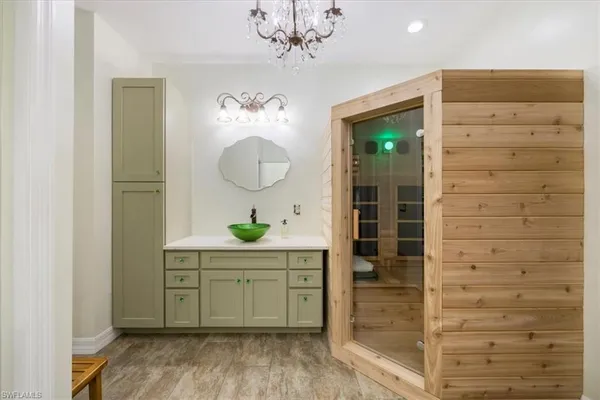 a view of a hallway with wooden floor and cabinet