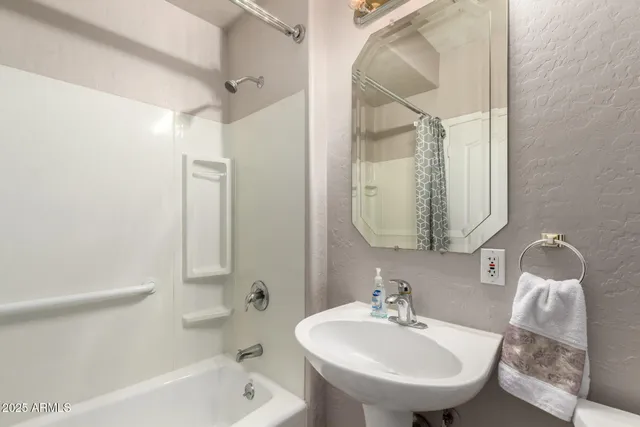 a bathroom with a sink a mirror and a bathtub