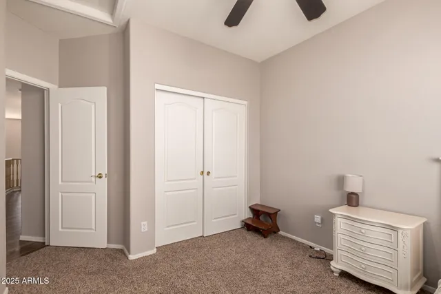 a room with furniture and a ceiling fan