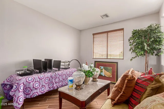 a living room with furniture and a potted plant