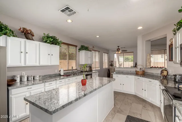 a kitchen with sink stove and cabinets