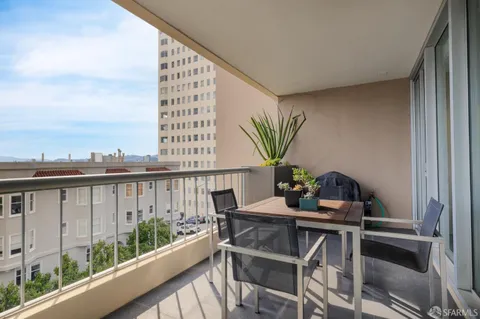 a view of a balcony with two chairs and a table
