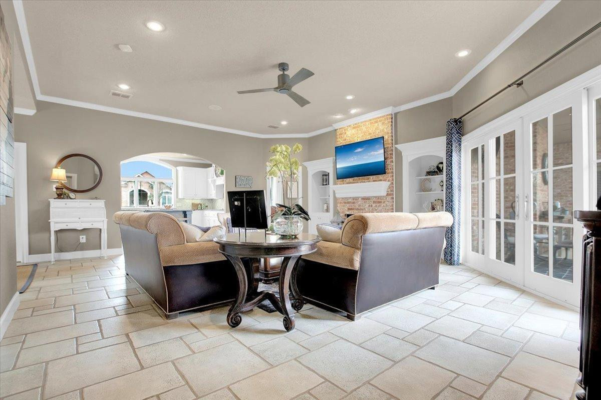 4818 104th Street Lubbock, TX 79424 - Photo 11 of 36 a living room with furniture a dining table and a fireplace