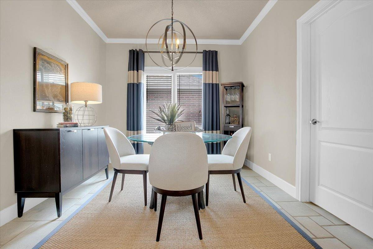 4818 104th Street Lubbock, TX 79424 - Photo 12 of 36 a view of a dining room with furniture window and wooden floor