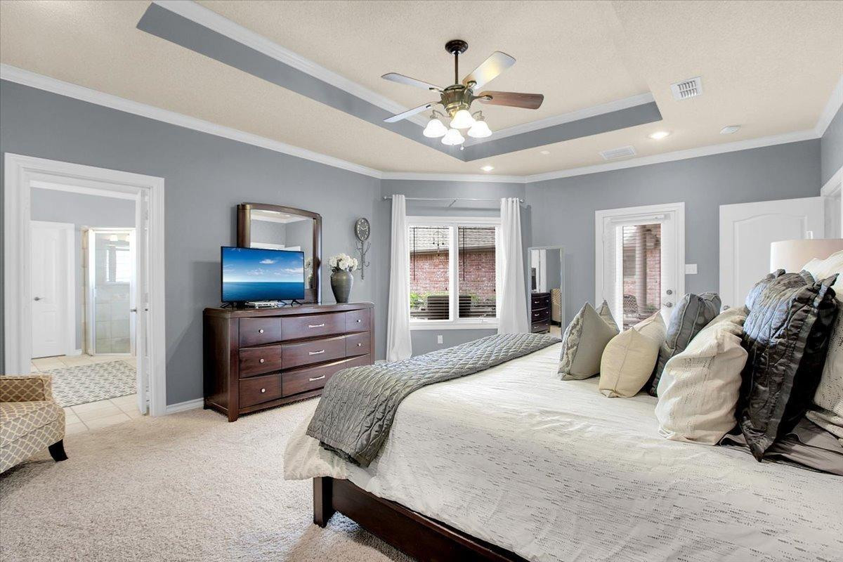 4818 104th Street Lubbock, TX 79424 - Photo 19 of 36 a bedroom with a bed and ceiling fan