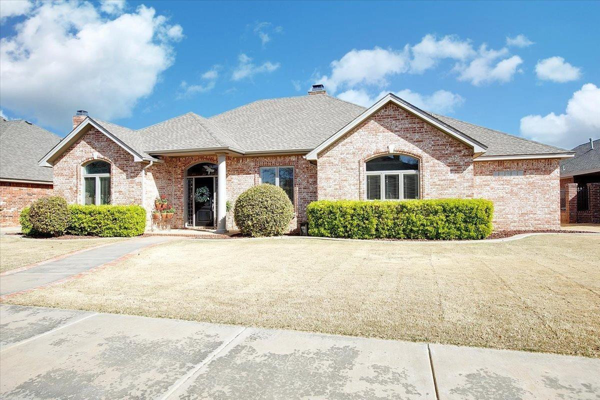4818 104th Street Lubbock, TX 79424 - Photo 2 of 36 a front view of house with yard and trees around