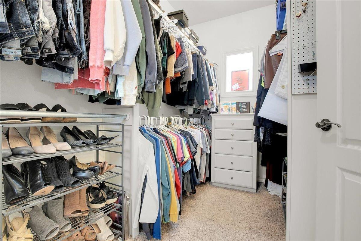 4818 104th Street Lubbock, TX 79424 - Photo 23 of 36 a view of walk in closet with clothes and shoes