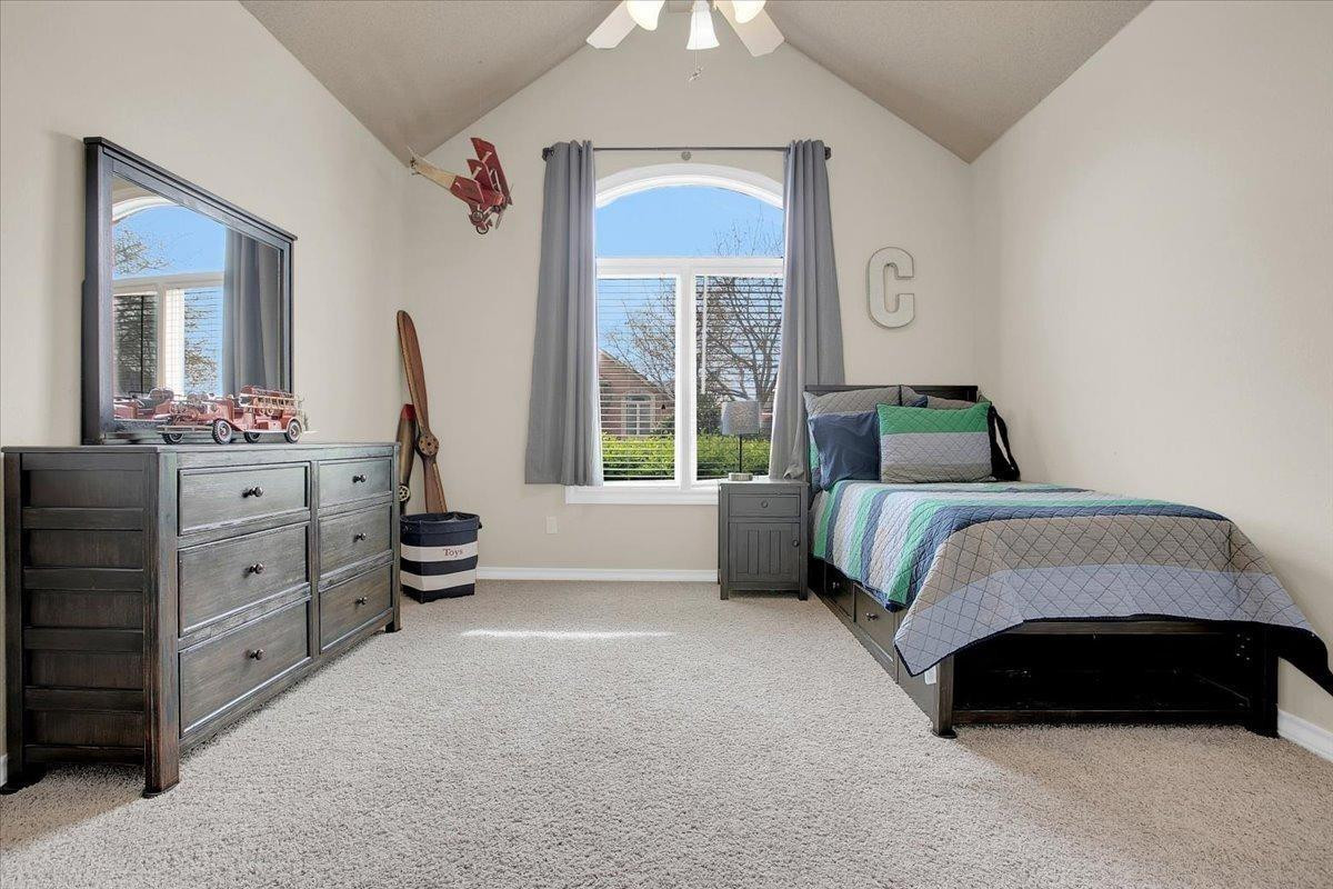 4818 104th Street Lubbock, TX 79424 - Photo 24 of 36 a bedroom with a bed and a dresser