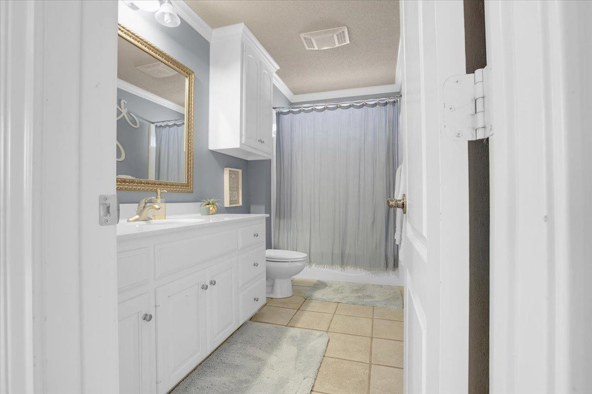 4818 104th Street Lubbock, TX 79424 - Photo 25 of 36 a bathroom with a sink a toilet and shower