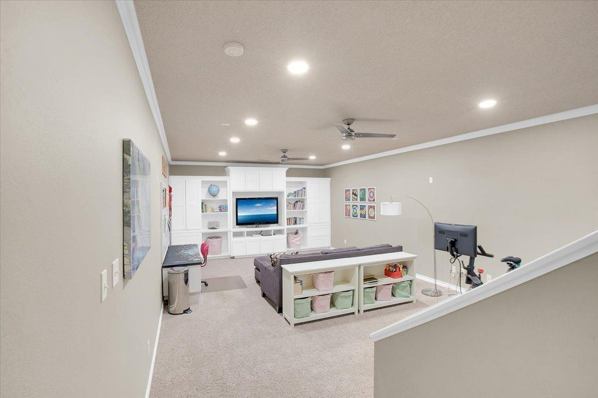 4818 104th Street Lubbock, TX 79424 - Photo 27 of 36 a living room with furniture and a flat screen tv