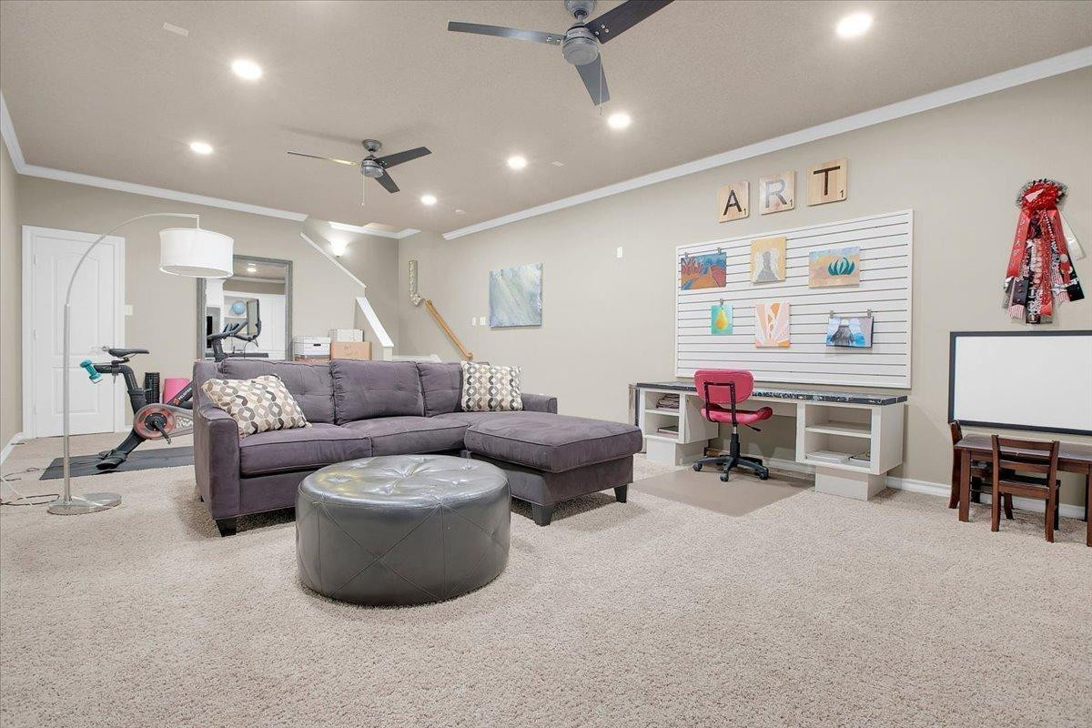 4818 104th Street Lubbock, TX 79424 - Photo 28 of 36 a living room with furniture and a flat screen tv