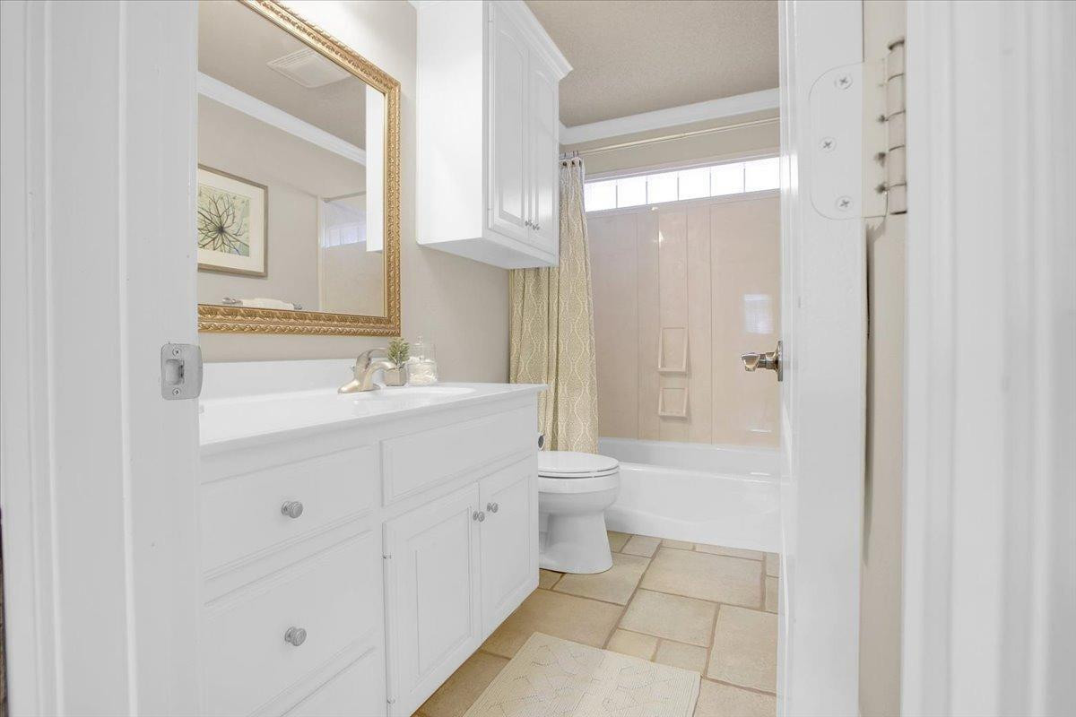 4818 104th Street Lubbock, TX 79424 - Photo 30 of 36 a bathroom with a sink a toilet and shower