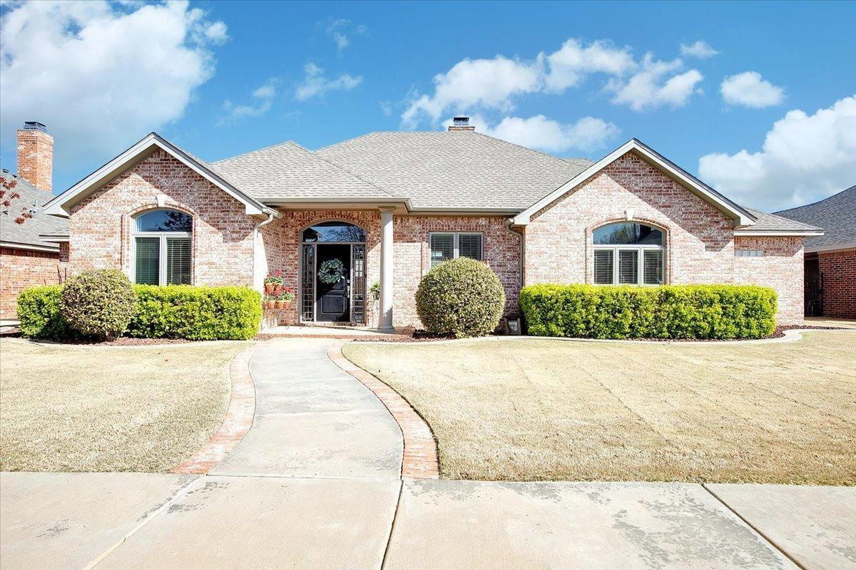 4818 104th Street Lubbock, TX 79424 - Photo 3 of 36 a view of a house with a yard and potted plants