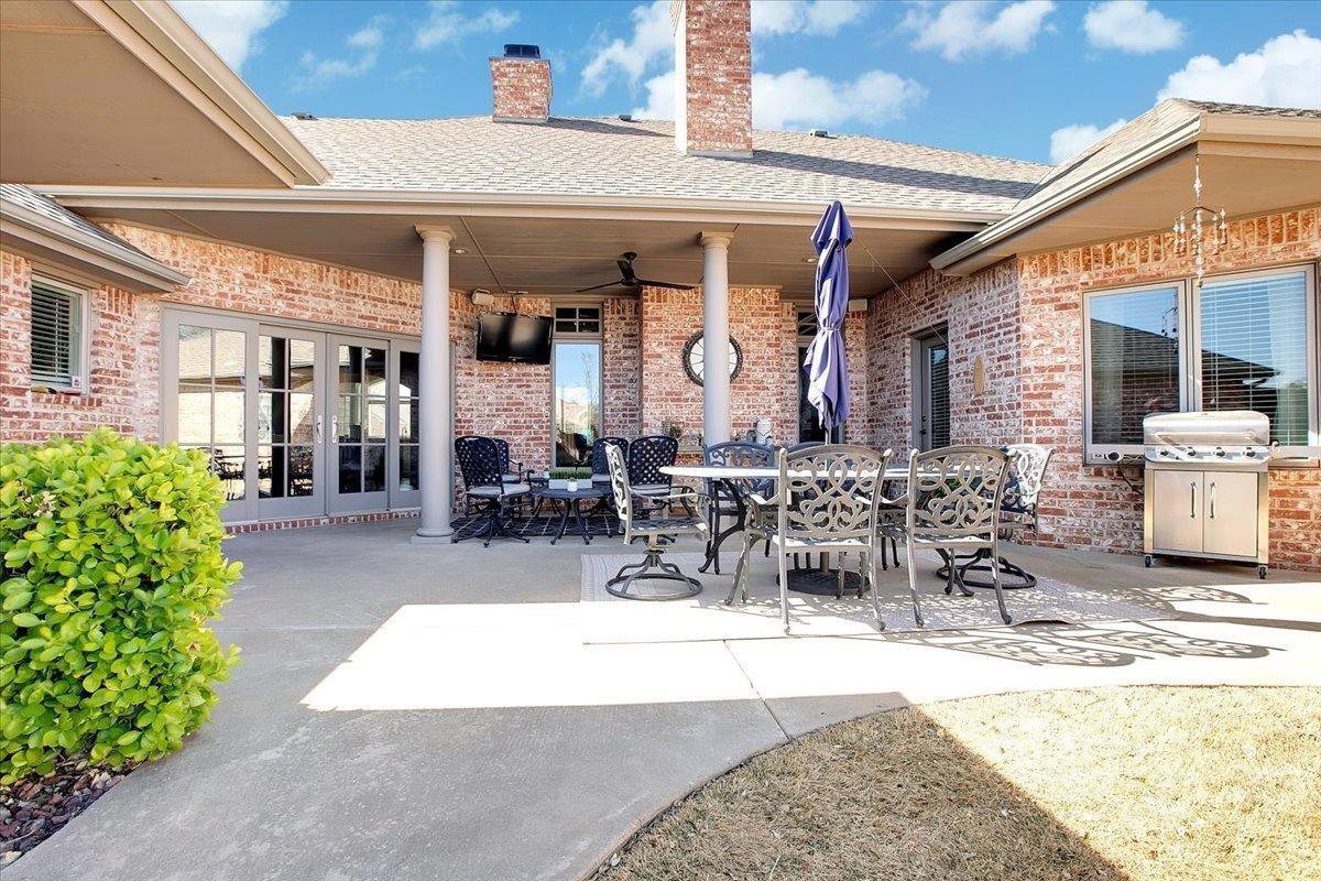 4818 104th Street Lubbock, TX 79424 - Photo 32 of 36 a view of a patio with table and chairs